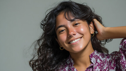 Fototapeta premium close up portrait of happy woman with curly hair smiling genuinely wearing hoop earrings perfect for beauty marketing haircare advertising and cosmetic brand content