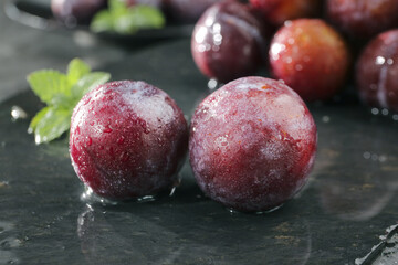 Fresh Red Plums with Water Droplets on Stone Surface - Healthy Organic Fruit © PhanThi
