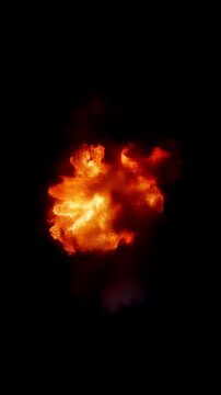 Glowing fireball blazing across an empty black background, vertical video featuring fiery energy, dramatic flames and cinematic visual effects