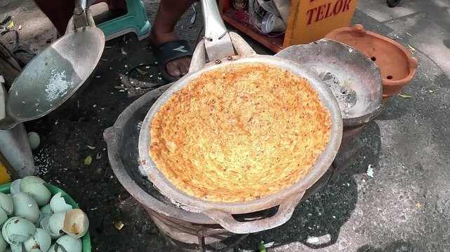 Kerak telor is a dish from the Betawi (Jakarta, Indonesia), consisting of an omelet mixed with white glutinous rice, dried shrimp, and spices.