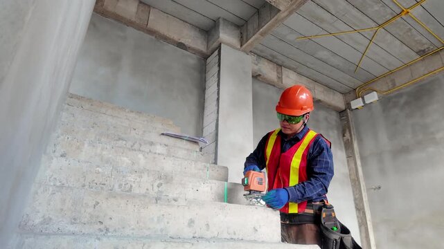 Construction workers wearing hard hats working on a building site with engineers and builders coordinating residential house construction project