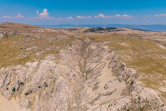 Drone photograph of the rugged limestone canyon and barren karst landscape above Stara Ba&scaron;ka on Krk Island, Croatia