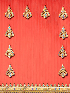 Detail of old wood wall with carved ornament in temple, Thailand. Vertical wooden background decorated with traditional ancient Thai decor. Mock up template. Copy space for text
