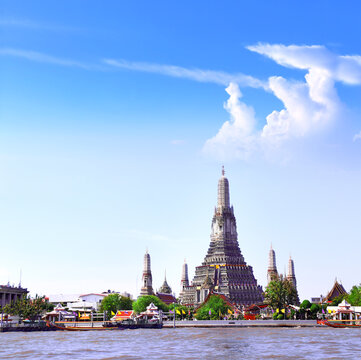 Buddhist Temple of Dawn Wat Arun, sightseeing landmark of Bangkok, Thailand. Famous tourist attraction boat ride on Chao Phraya river. Summer vacation, relaxing, topic of travel, trip, cruises, tour