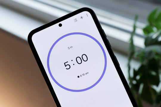 Phone with 5-minute timer counting down to study or be productive. Five minutes countdown for productivity, working, studying and active time. Horizontal photo.