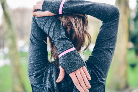 Mid adult woman warming up before running
