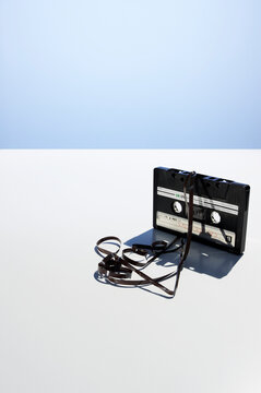 Tangled vintage audio cassette with unwound recording tape