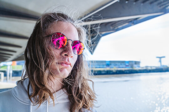 Teenager with pink eyewear expressing modern style