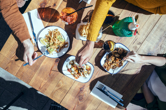 Male and female friends having tapas in restaurant
