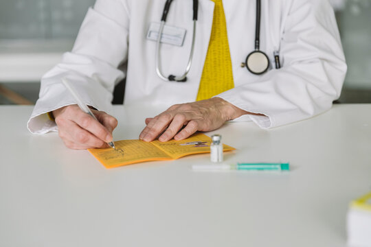 Doctor filling out immunization card