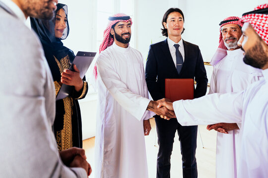 International business executives shaking hands at a meeting