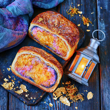Mooncake Slices with Lantern on Dark Wooden Table