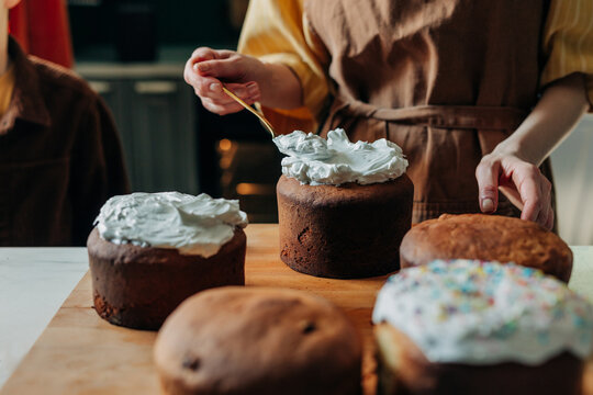 Baker decorating traditional Easter paska bread in kitchen