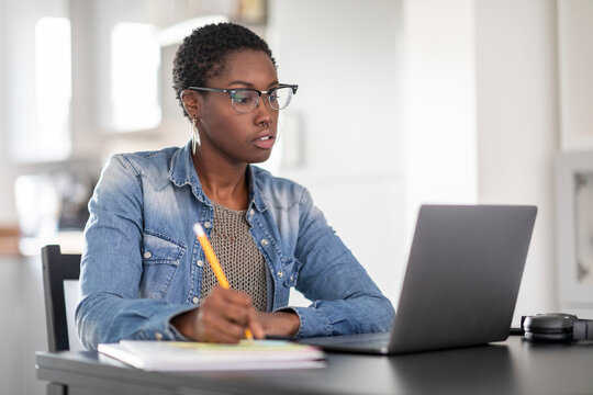 Woman working on laptop at home