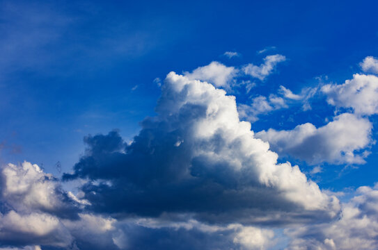 Dramatic cumulus clouds in a bright blue sky over Austria