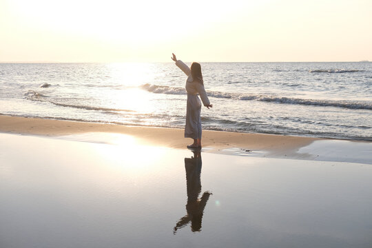 Traveler relaxing on the sandy beach in Poland at sunset