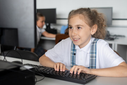 Elementary School Girl Typing on Computer Keyboard