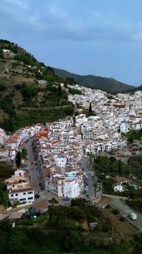 Vertical panoramic aerial view of Frigiliana a picturesque white town on the Costa del Sol located in the Sierra de Almijara mountains in southern Spain