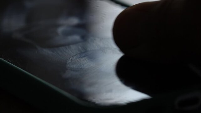 Dirty phone screen that needs cleaning. Fingerprints on a mobile phone screen.
