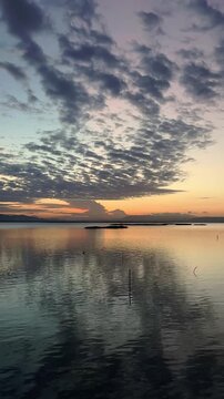 Timelapse of Sunset Over Calm Water with Clouds
