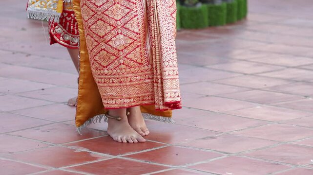 Close Up of Barefoot Thai Dancers in Traditional Silk Costumes