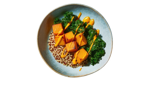 Quinoa bowl with roasted butternut squash kale, and creamy dressing