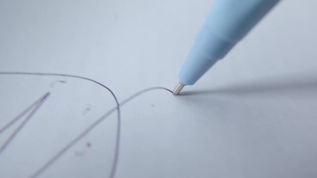Macro of a Pen Tip Drawing Freehand Lines on White Paper, Showcasing Handwriting, Sketching, Creativity, Stationery, and Artistic Expression