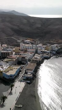 Aerial view of the Tarajalejo, town situated on the slopes of volcanic coast of the southern part of the Fuerteventura Island, Canary Islands, Spain.