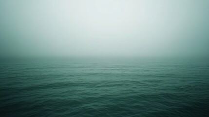Fototapeta premium Calm sea under misty sky tranquil water hazy atmosphere