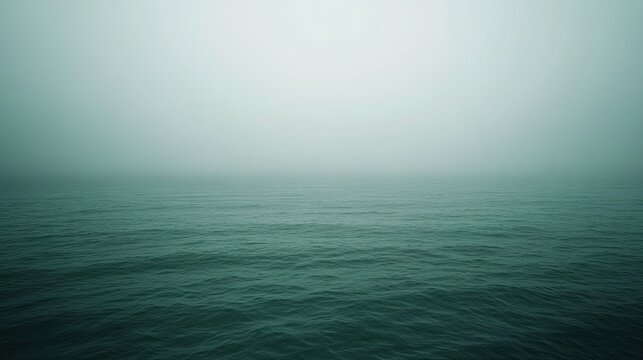 Calm sea under misty sky tranquil water hazy atmosphere