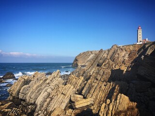 Penedo da Saudade Lighthouse on a rocky cliff overlooking the Atlantic Ocean, Marinha Grande, Leiria, Portugal, December 2018 © Sergei