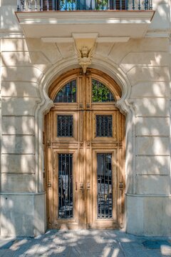 Wooden Door On Historic Facade In Barcelona, Ornate Modernist, Eixample District, Panot Tiles, Classic Arch
