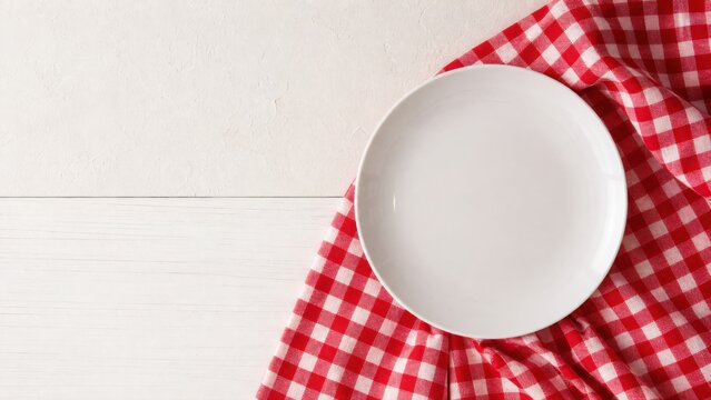 White Ceramic Plate Rests On Red Checkered Tablecloth Over Rustic Wood Surface Providing Minimalist Composition For Menu Design Food Advertising