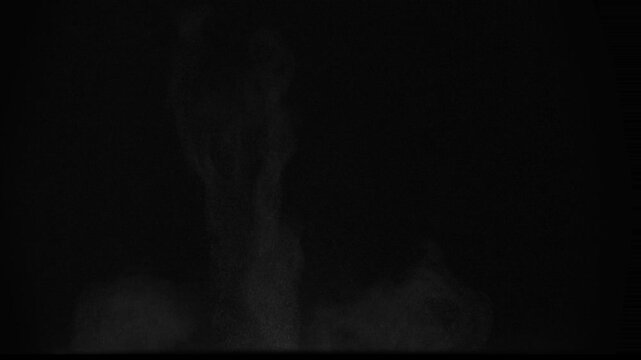 Heavy Hitting the Ground. A column of soil and dust rises into the air from the explosion. Isolated on black. Use in blend modes to simulate a battlefield