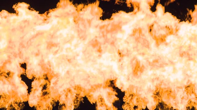 Fiery Wall of Bright Flame. A dense flow of a seething fiery stream from bottom to top on a black background. Slow Motion