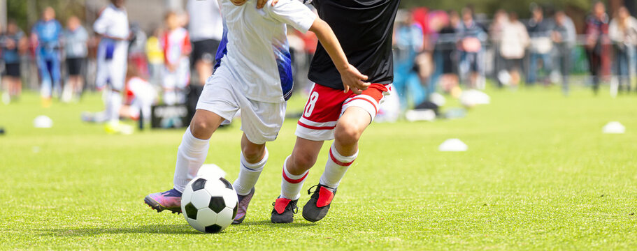 Kids Soccer Dribbling Duel: Action Shot of Junior Football Players Vying for Ball. Youth Soccer Tournament
