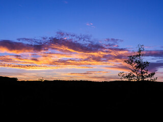 Fototapeta premium Peaceful Sunset Clouds Over A Dark Rural Horizon