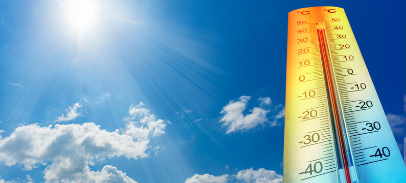 Thermometer showing high temperature under hot sunny sky