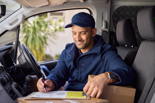 Satisfied courier signing delivery receipt