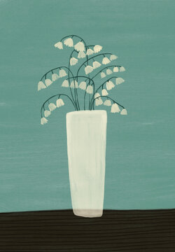 A vase on a table with lily of the valley