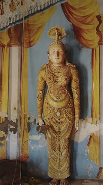 Elegant Statues Surrounded by Stunning Temple Mural Works