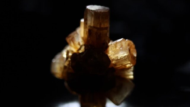 Aragonite mineral close up on black background. Dramatic light, reflections. Slow zoom. Macro video of hedgehog or sputnik cluster