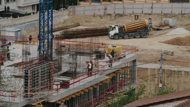 Timelapse showing construction workers and heavy machinery building the reinforced concrete foundation of a modern high-rise building, demonstrating the rapid pace of urban development
