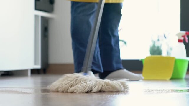 One person mop or clean floor for hygiene disinfection, dust maintenance or dirt task. Housekeeping, feet and equipment for maid service in house for wood ground, bacteria or germ removal at home.