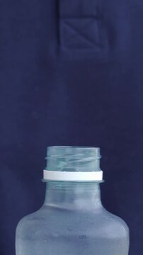 Man opening plastic bottle with clean water. Water benefits for skin and health