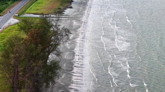 Road runs parallel to the coastline