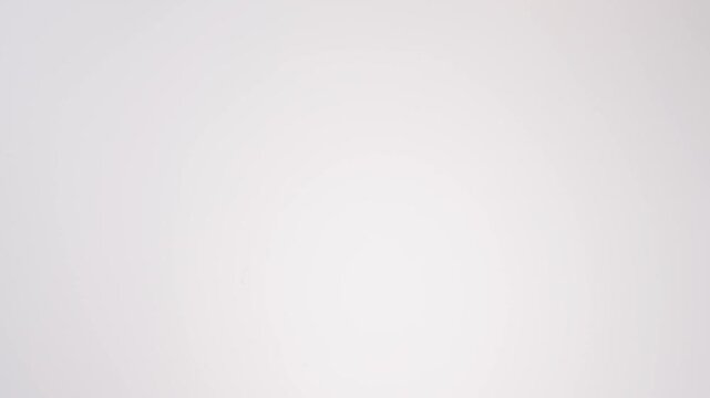 Everything-seeded savory bagels streaming down on white tabletop in mesmerizing slow motion. everything seasoning brand commercials, sunday brunch content, cream cheese ads.