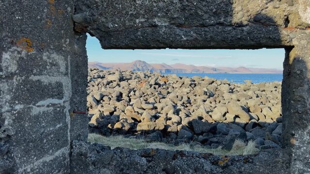 Volcanic Rocks Seen Through The Window Of An Abandoned Building In Hopsnes, Grindavik, Iceland. - handheld shot