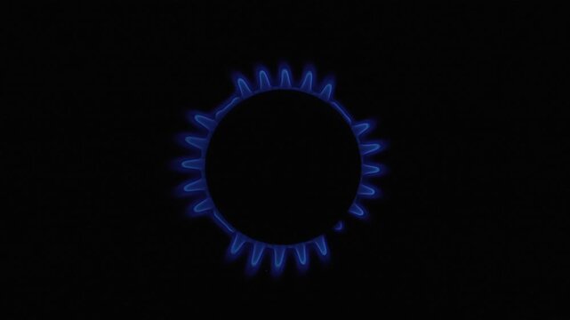 A circular pattern of blue flames burns brightly on a stove, creating a striking contrast against the dark background. Suitable for energy-related content or cooking tutorials.