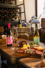 Fototapeta premium Wine selection displayed on racks and barrels around tasting table, selection includes local and imported bottles for every palate, selection advice given by staff during relaxed sampling session.
